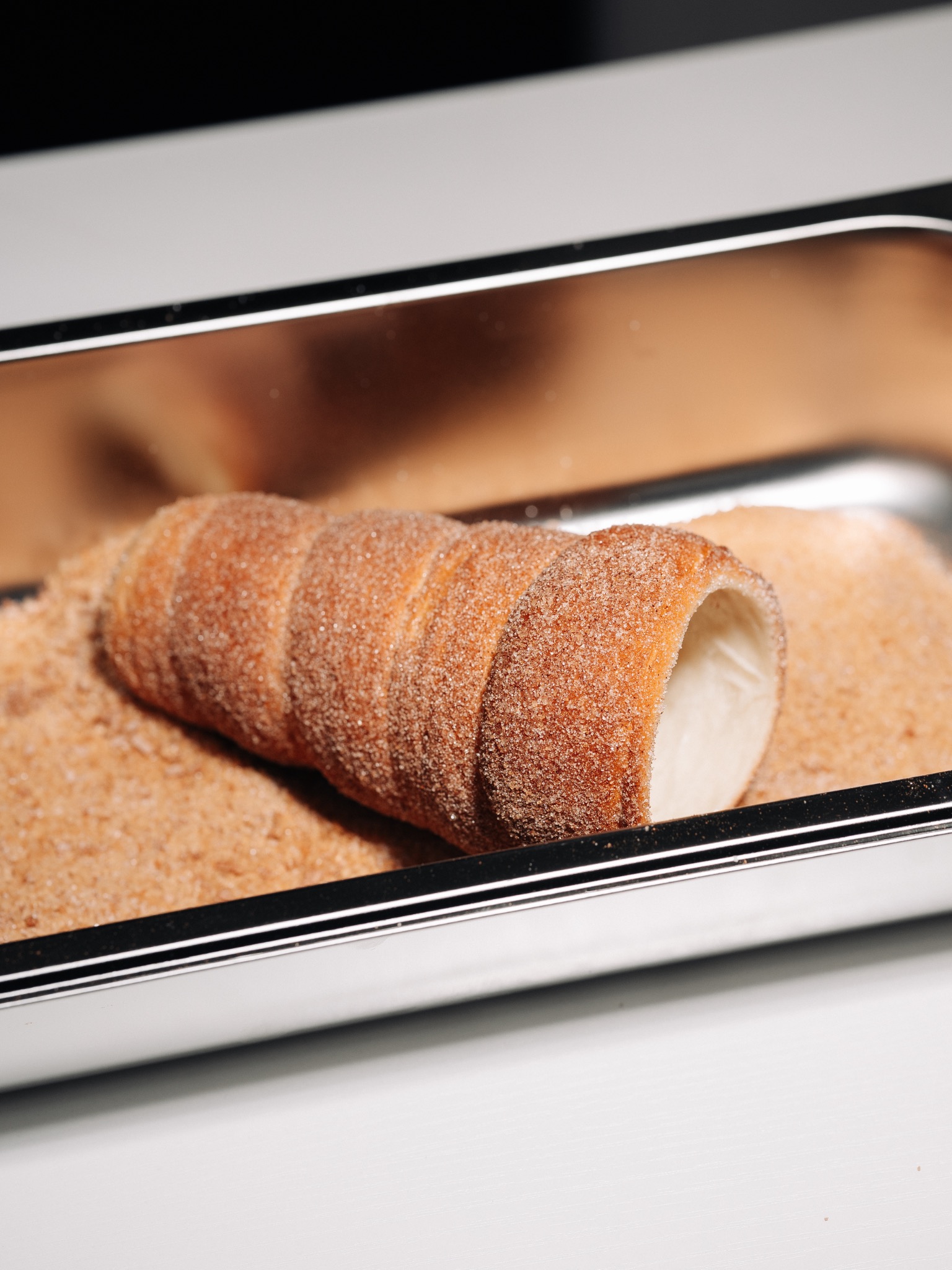 Classic cinnamon chimney cake baking on the machine