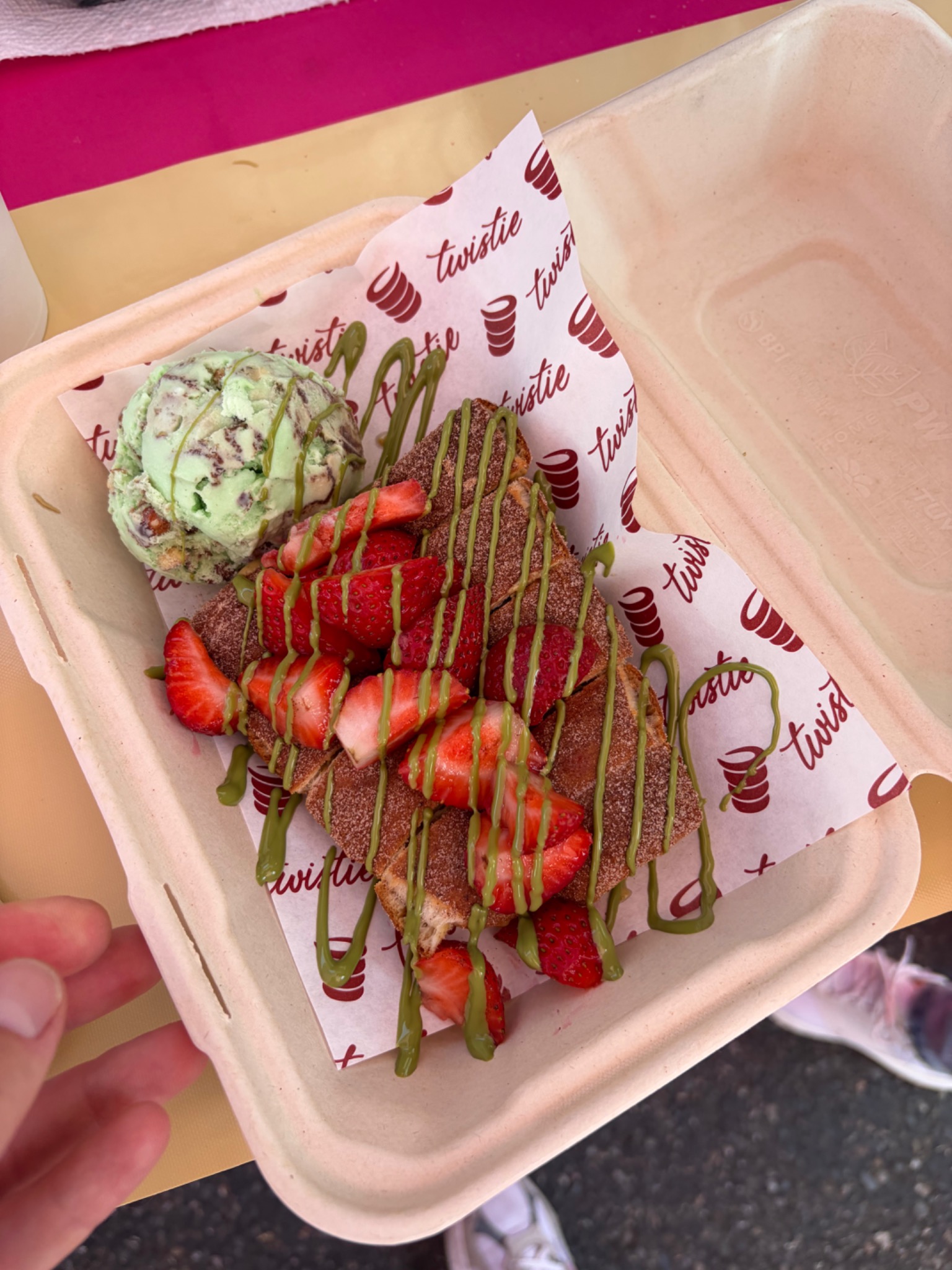 Chimney cake dessert with strawberries and pistachio drizzle
